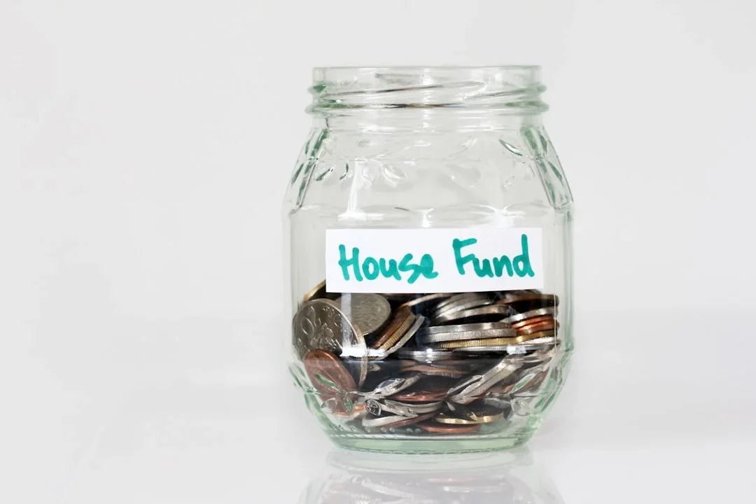 Person calculating emergency fund savings with calculator and budgeting worksheets