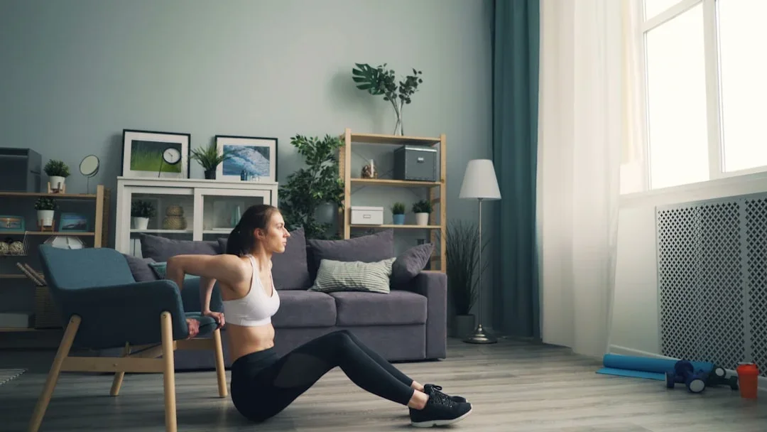 Person doing bodyweight exercises in a home living room setting